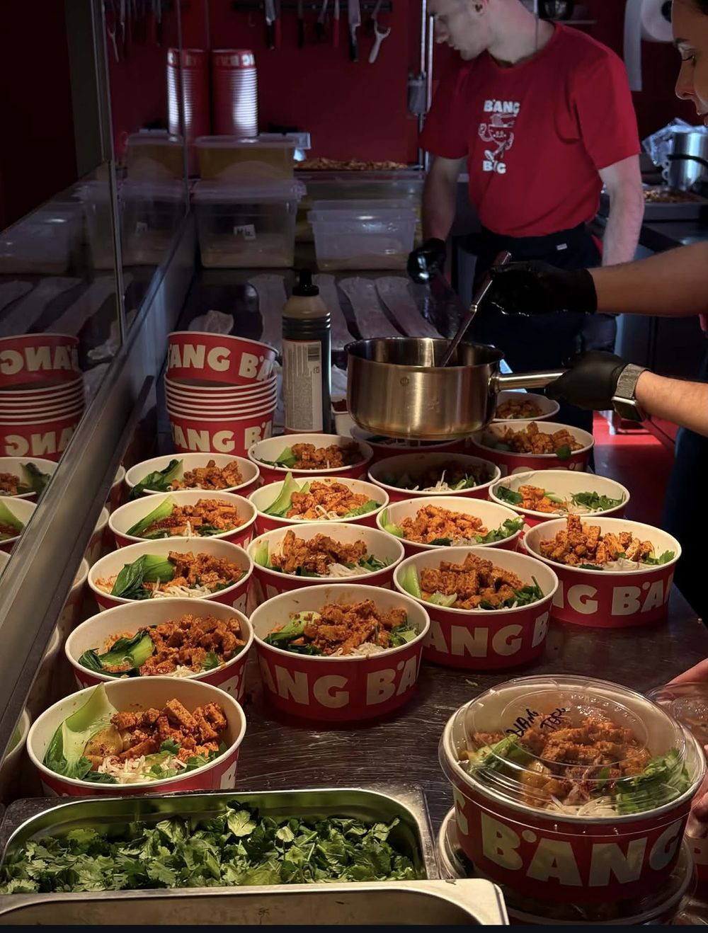The open kitchen with rows of finished BANG BANG bowls