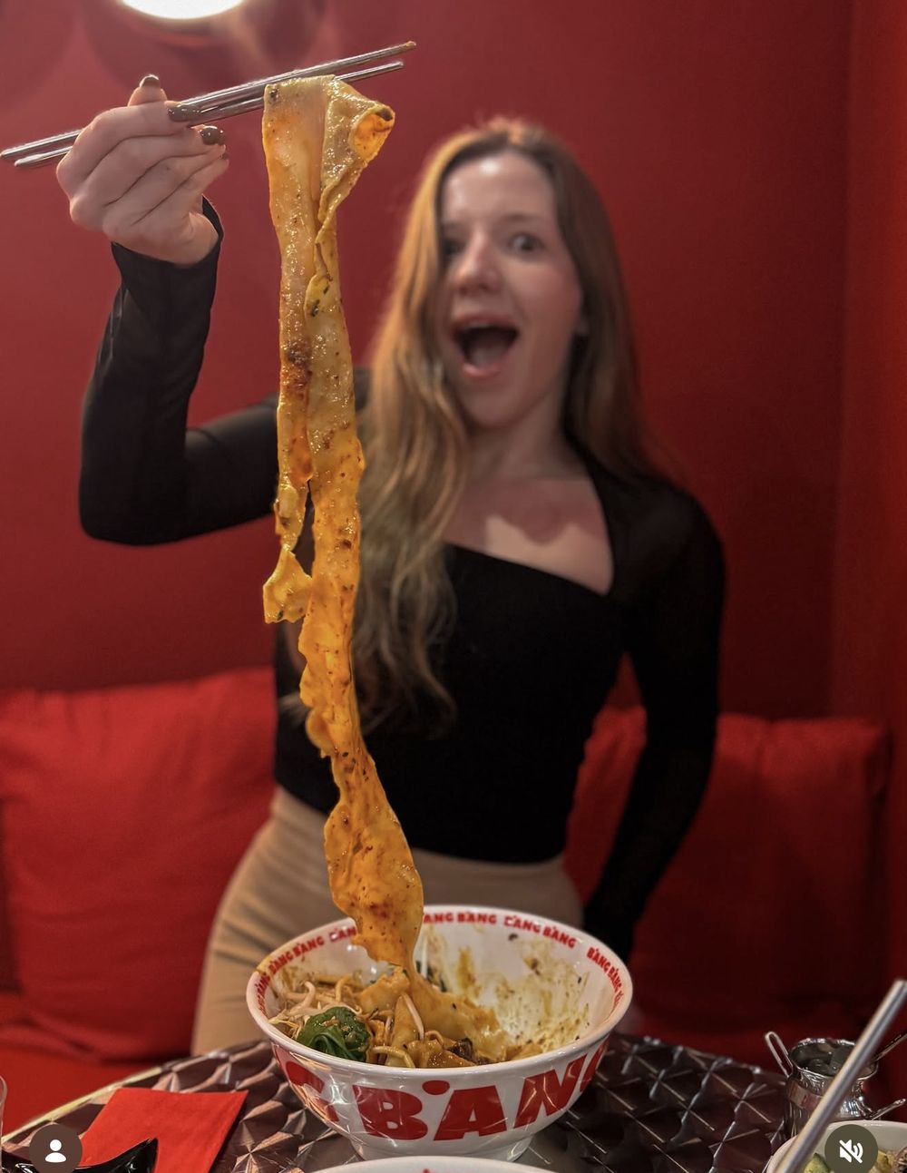 Guest lifting a long noodle